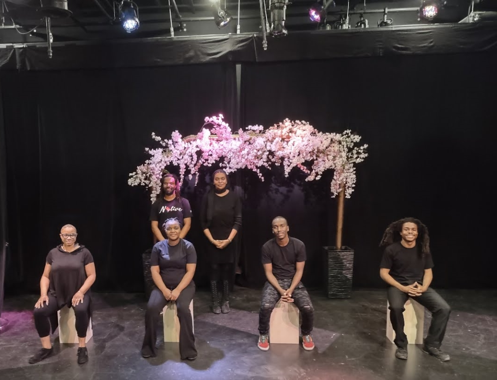 Cover photo for the 2022 Year in Review. Shows a group of teachers standing and sitting on a stage